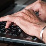 Hands at a computer keyboard