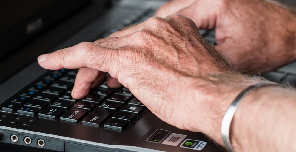 Hands at a computer keyboard